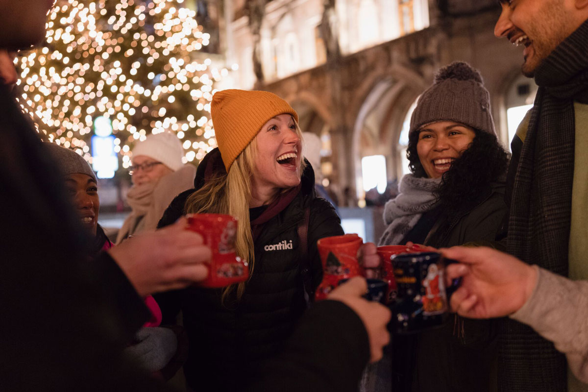 Friends0enjoying A Hot Drink In A Christmas Market
