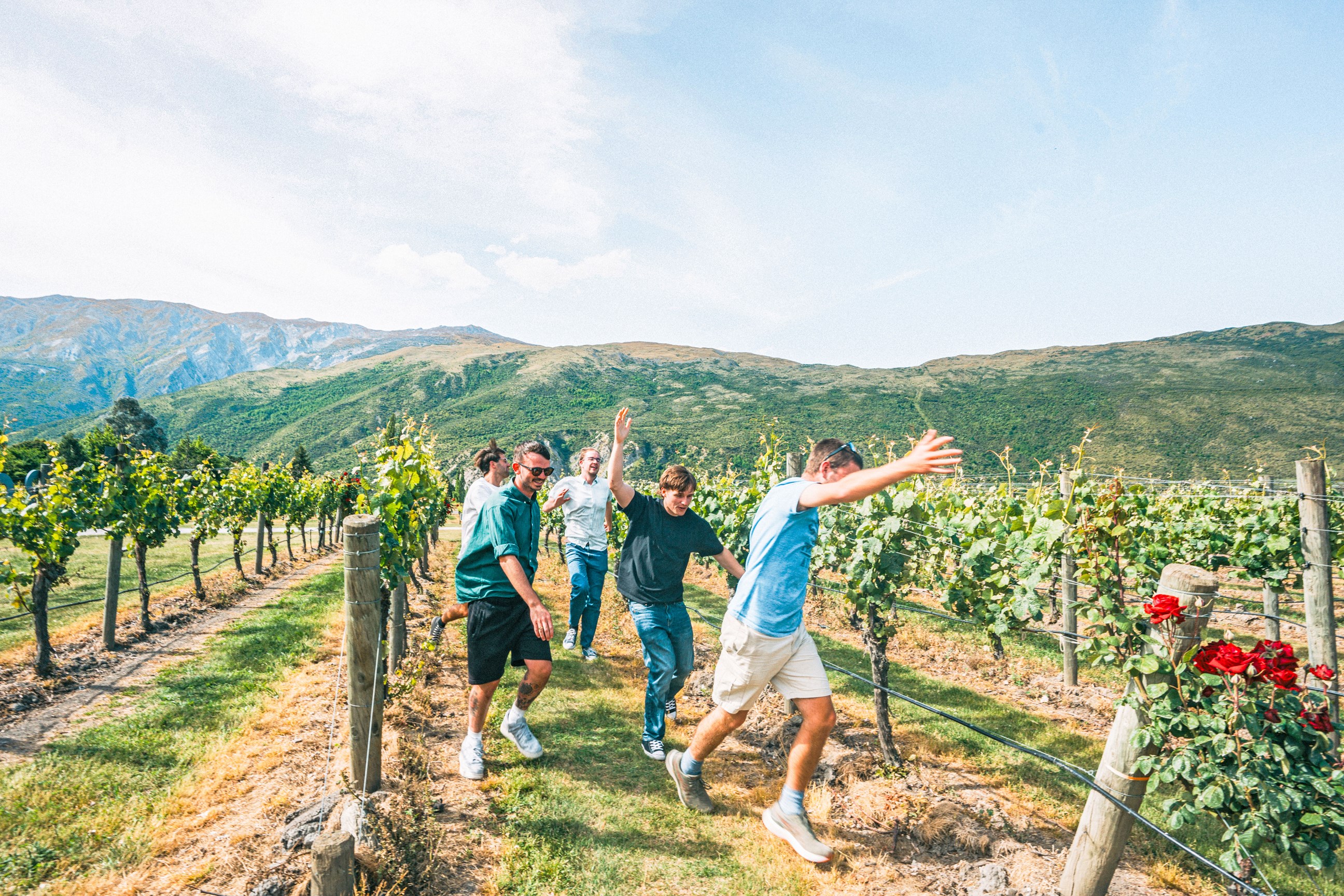 Travellers enjoying a wine tasting during their vineyard tour in Queenstown, New Zealand