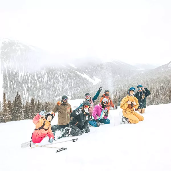 People Enjoying A Day Of Snow Snowy Mountains At The Back