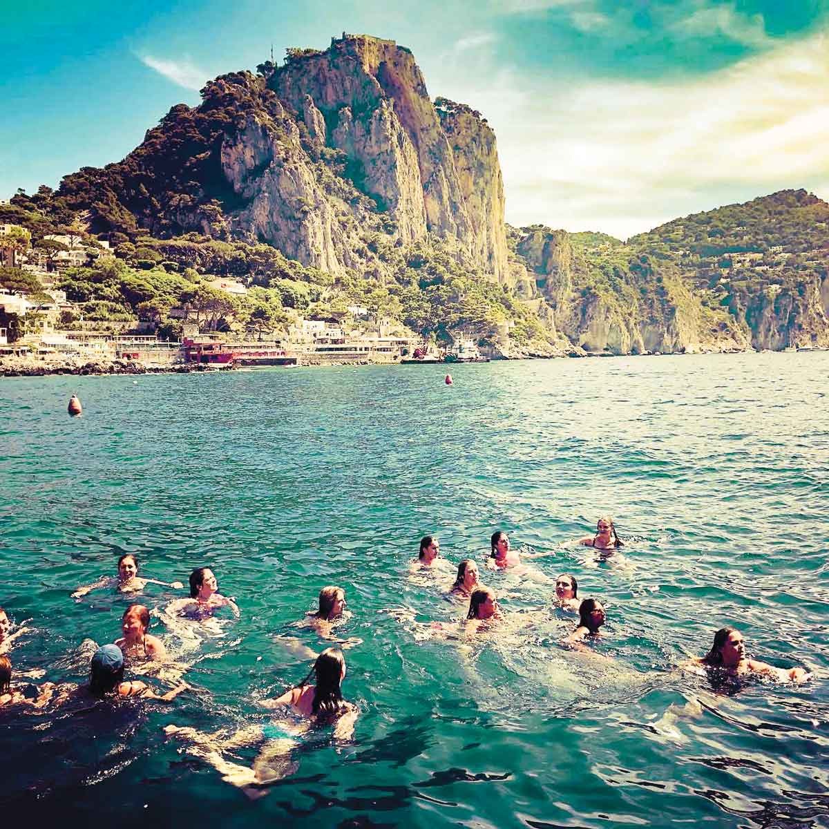Group Swimming In The Sea On Amalfi Coast Italy