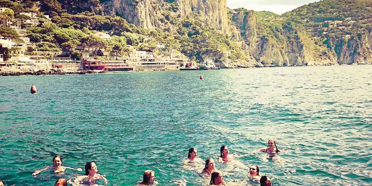 Group Swimming In The Sea On Amalfi Coast Italy