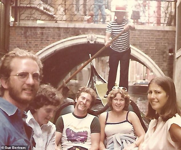 Five young friends riding a gondola in Venice, Italy.