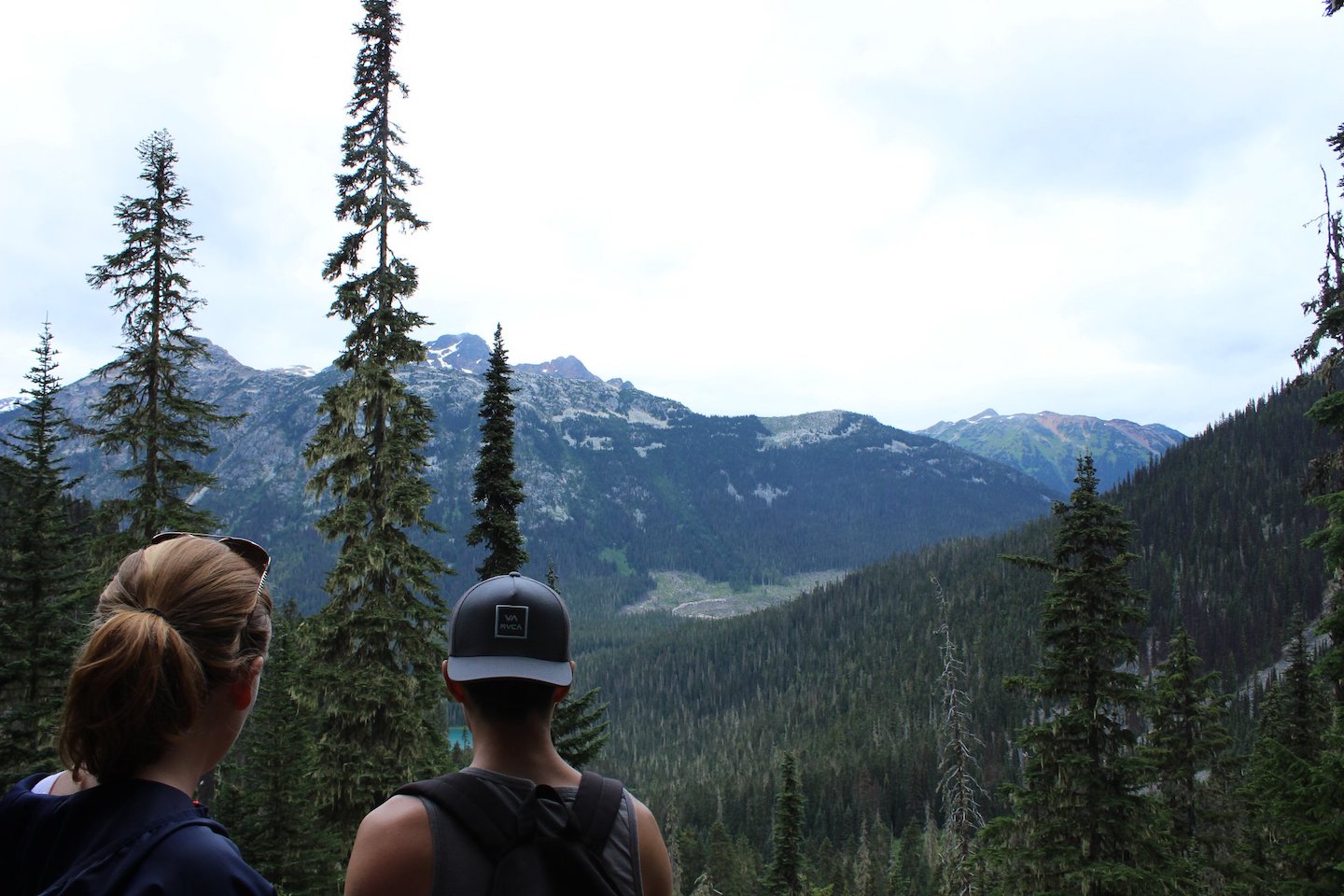 Two young friends stare at the mountains beyond Joffre Lakes Provincial Park in Vancouver, Canada.