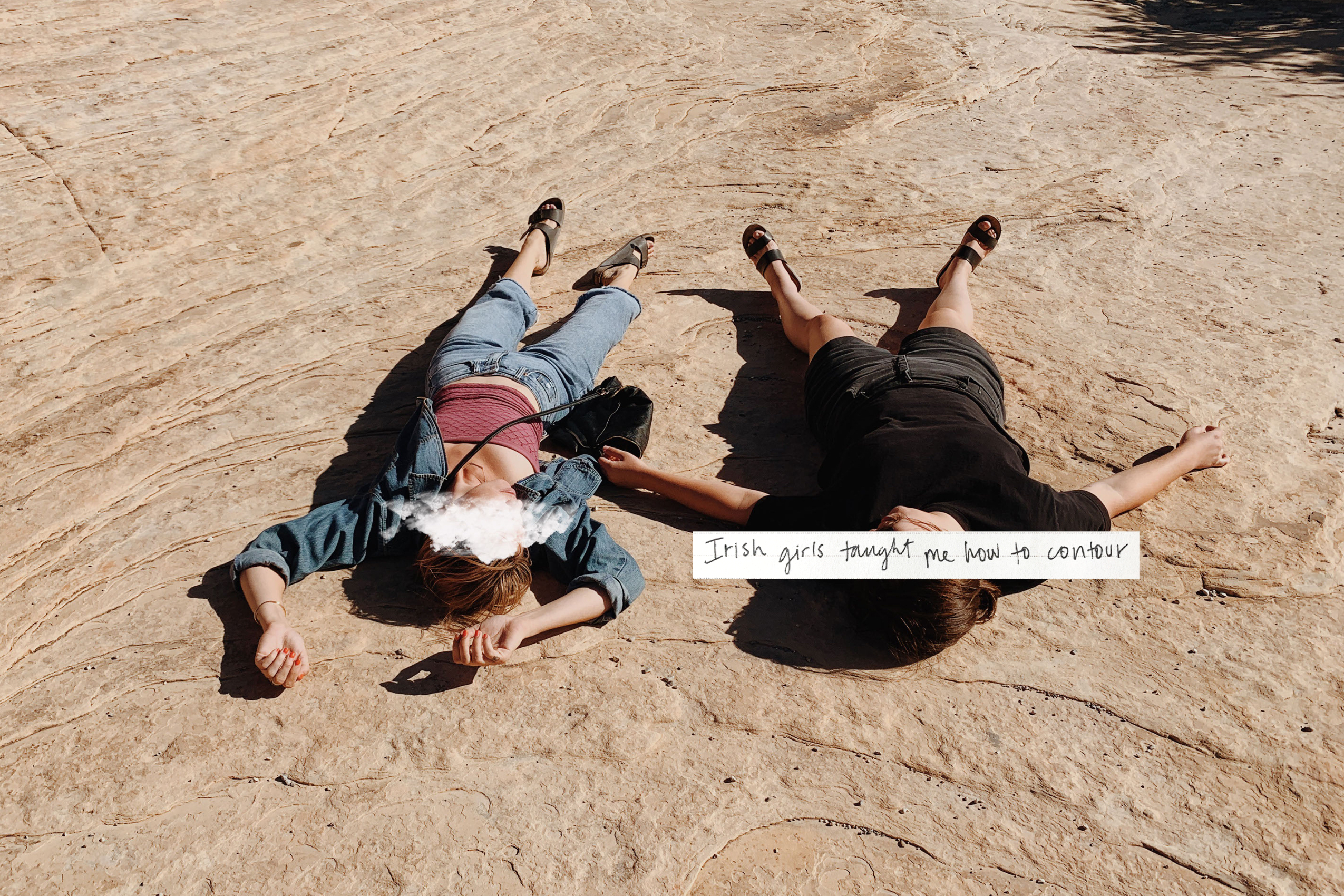 Two young friends lying on the ground.