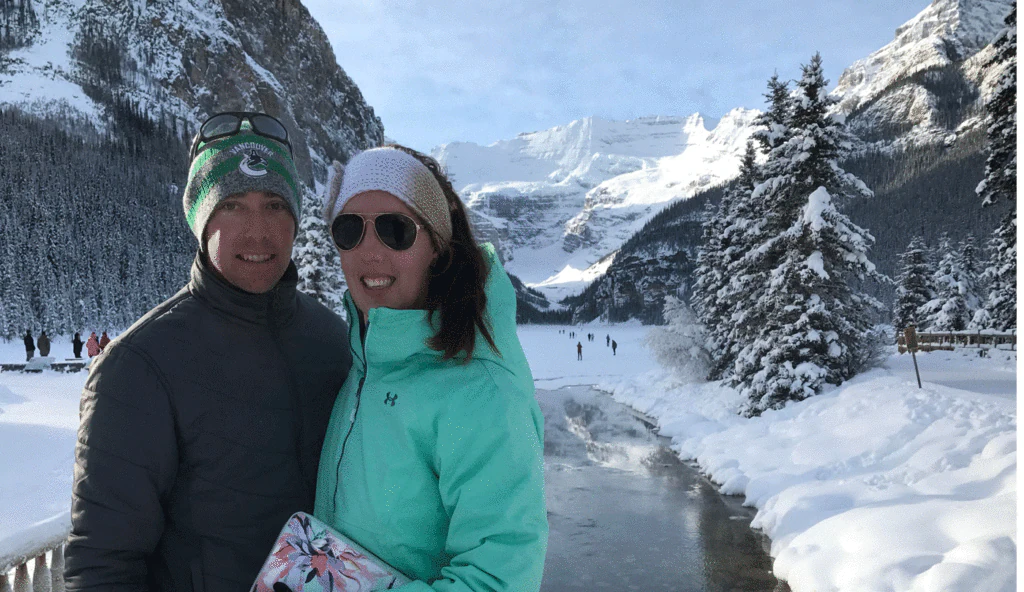 Steph & Shaun in front of snowy mountains in Canada.