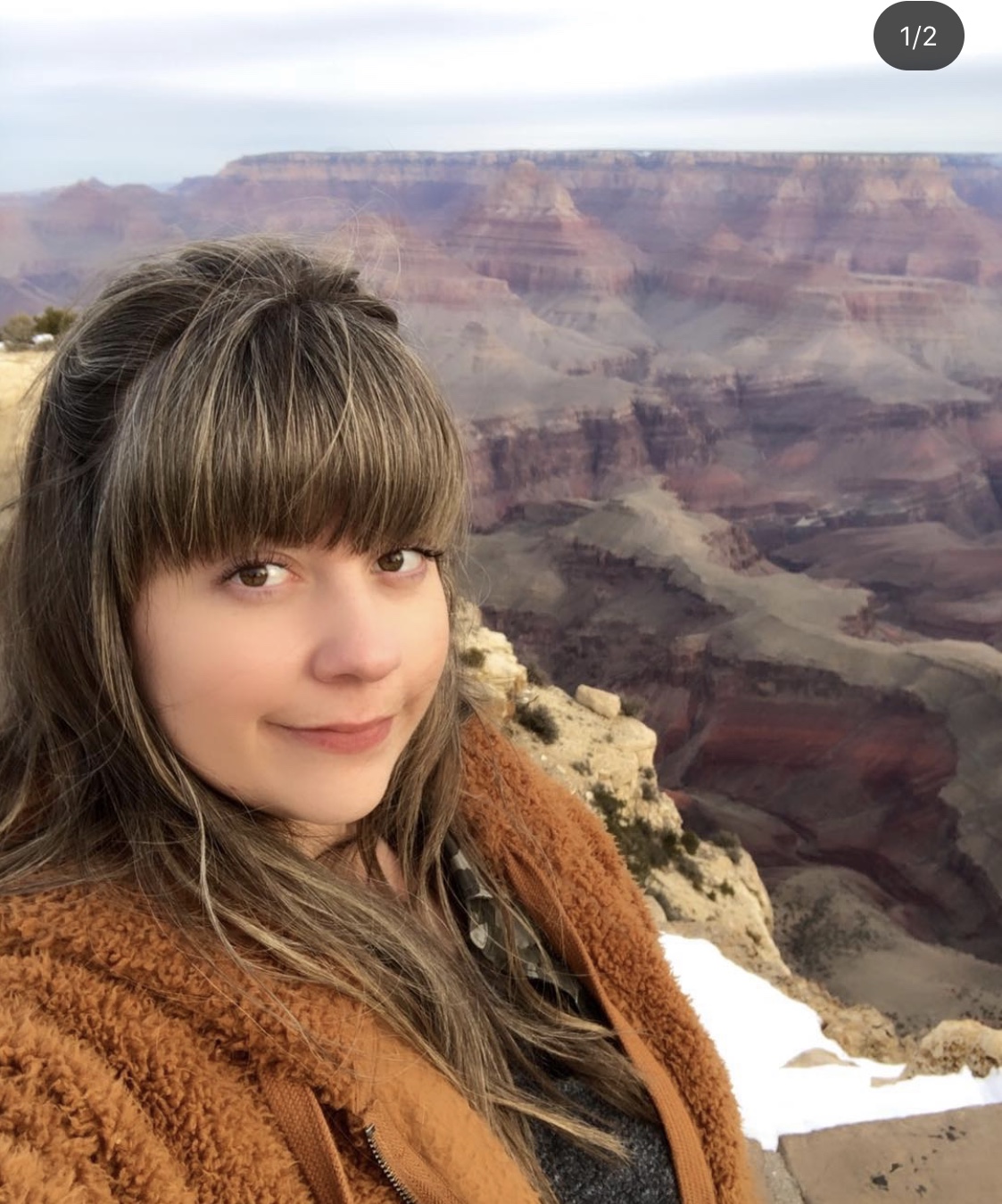 Young woman standing in front of the Grand Canyon, Arizona, USA.