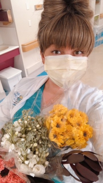 Young woman holding flowers.