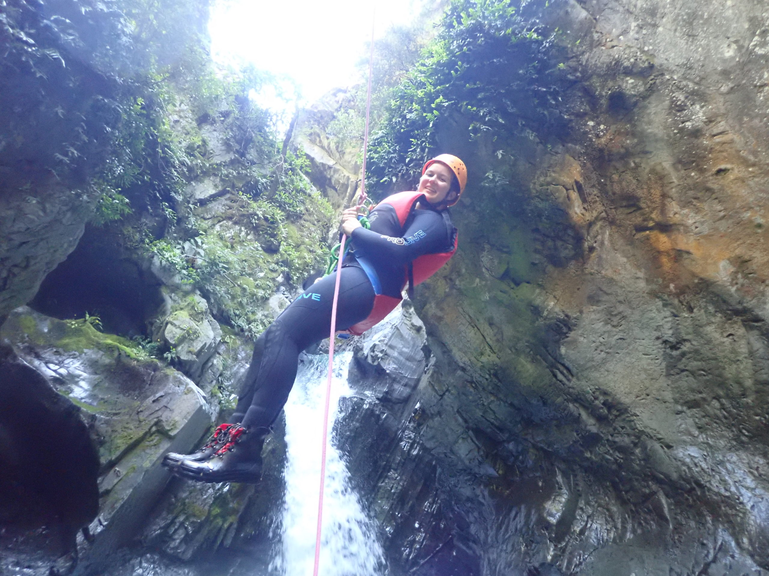 Young woman canyoning in Queenstown, New Zealand.