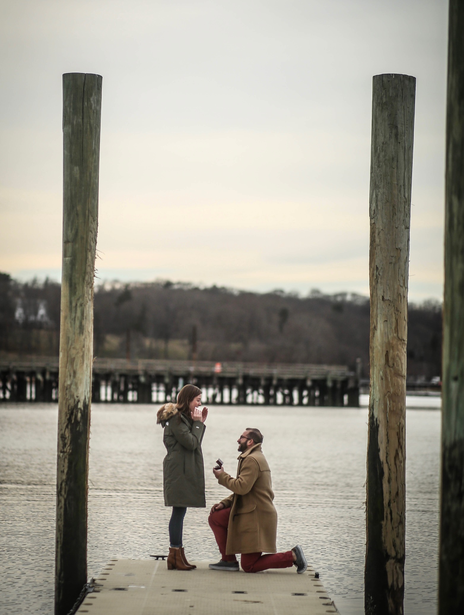 Jillian's fiancé proposing to her on a pier.