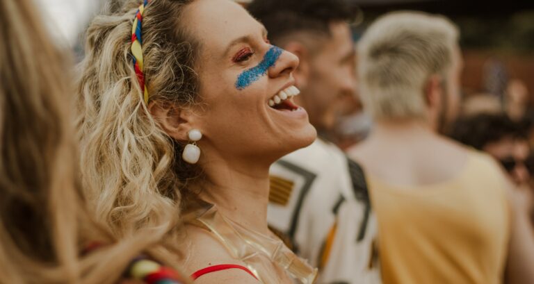 A woman laughing at a festival in 2023.