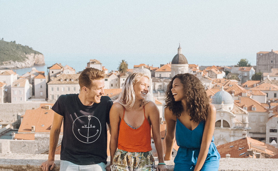 Three people standing on a balcony in Rome