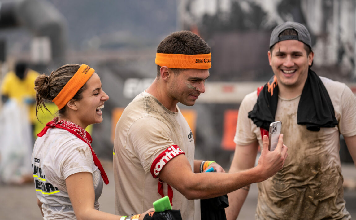 A group of people taking a selfie at Tough Mudder.