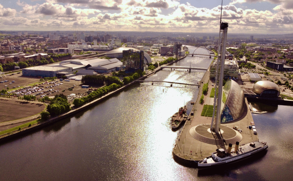 A boat is docked near a city.