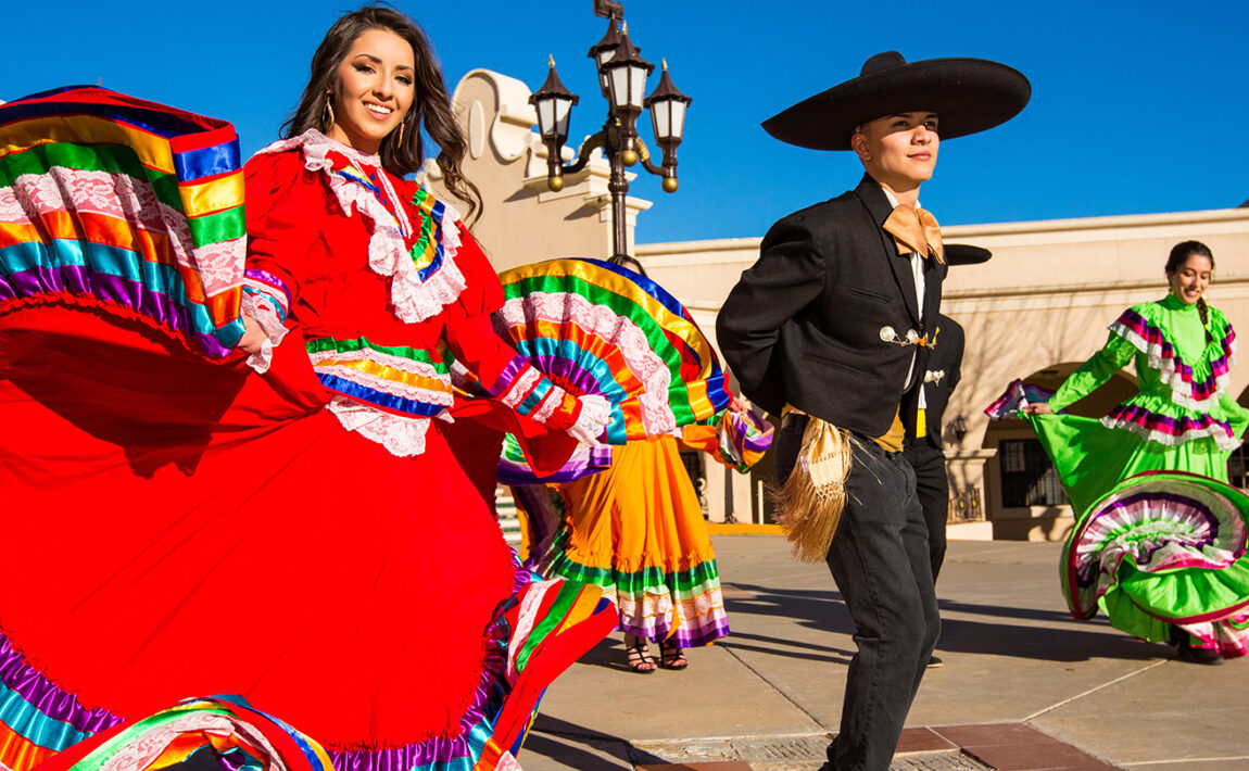 A group of Mexican dancers in colorful costumes, perfect for celebrating Cinco de Mayo.
