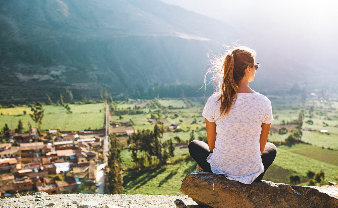 A woman is overlooking a village in South America.