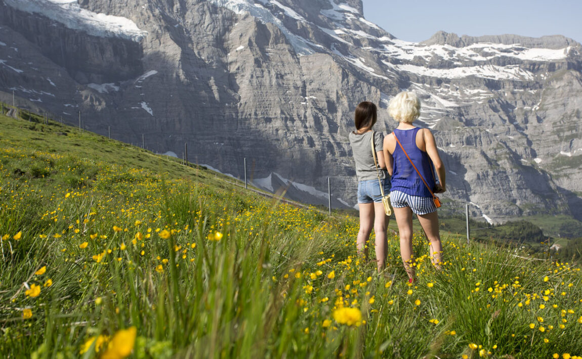 what to pack for a holiday in switzerland - image of two girls looking over the mountains in Switzerland