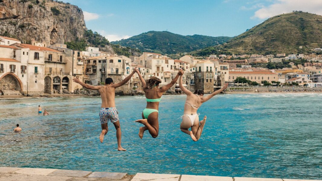 friends jumping into the water