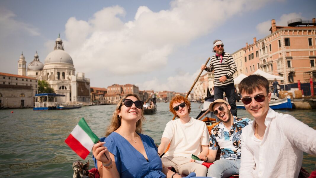 Contiki travellers on a gondola in Venice, Italy
