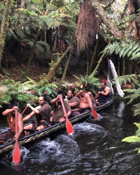Māori men paddling on a waka
