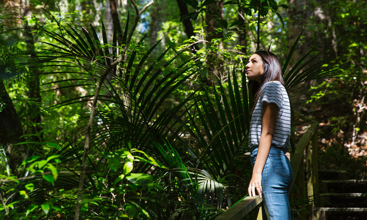 Girl-surrounded-by-fauna-in-New-Zealand