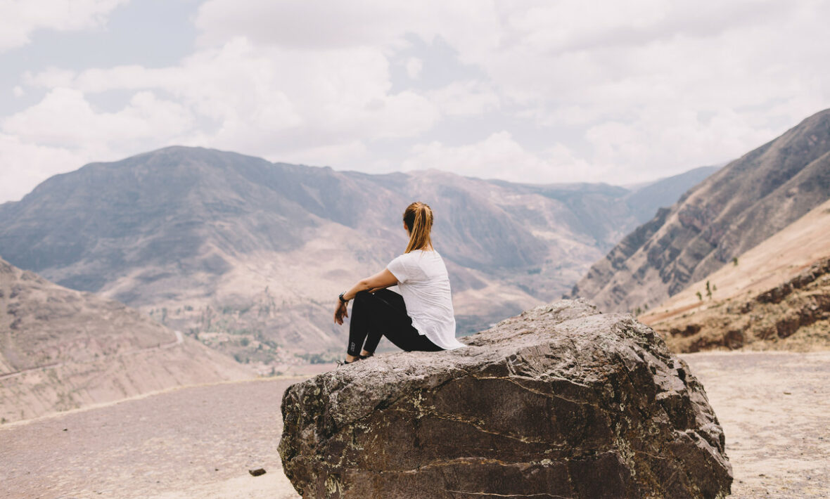 Girl sitting on rock