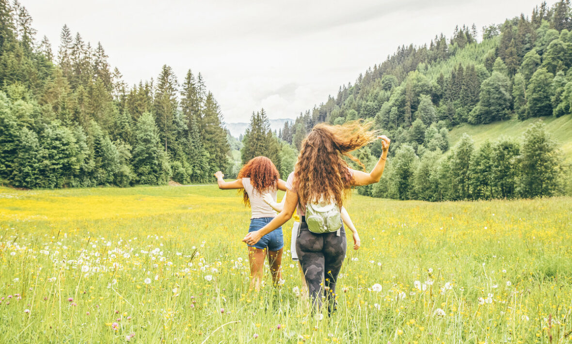 Two girls running through fields