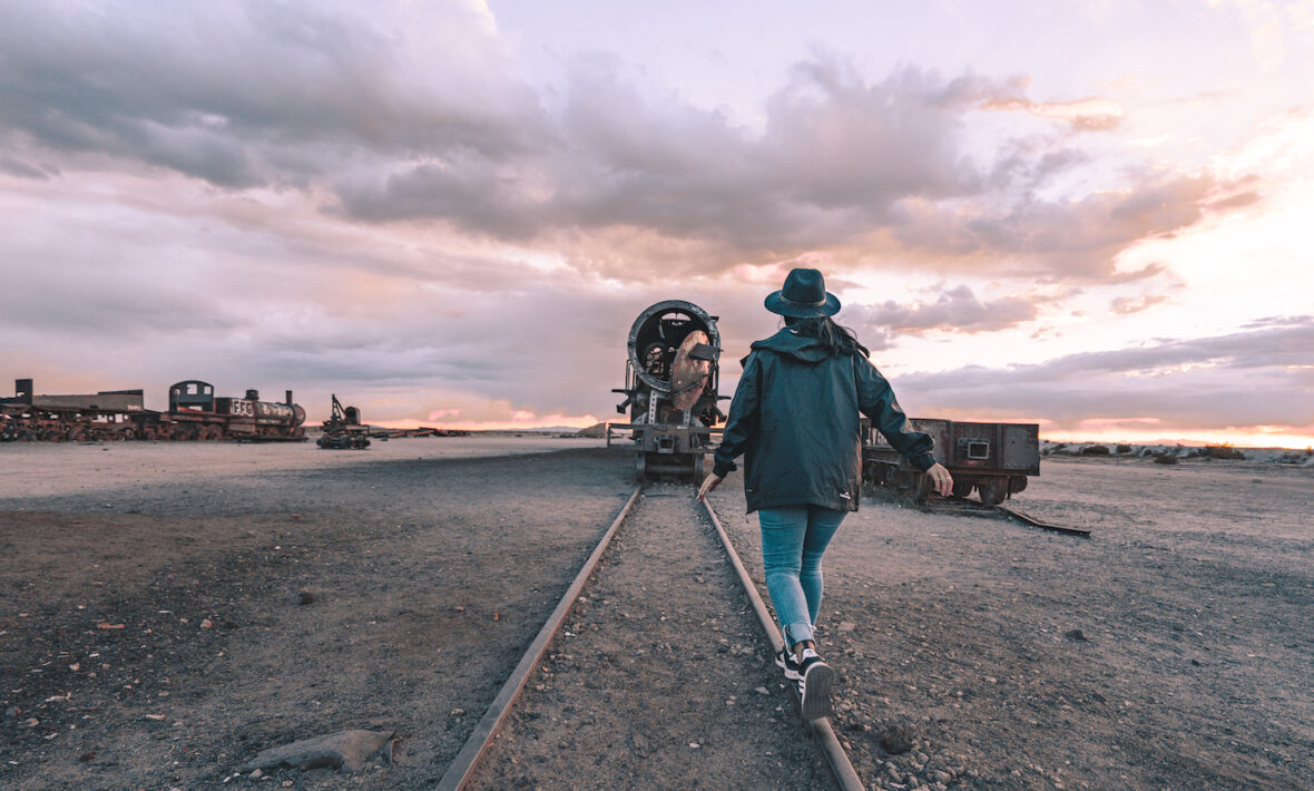 Woman walking on abandoned train tracks