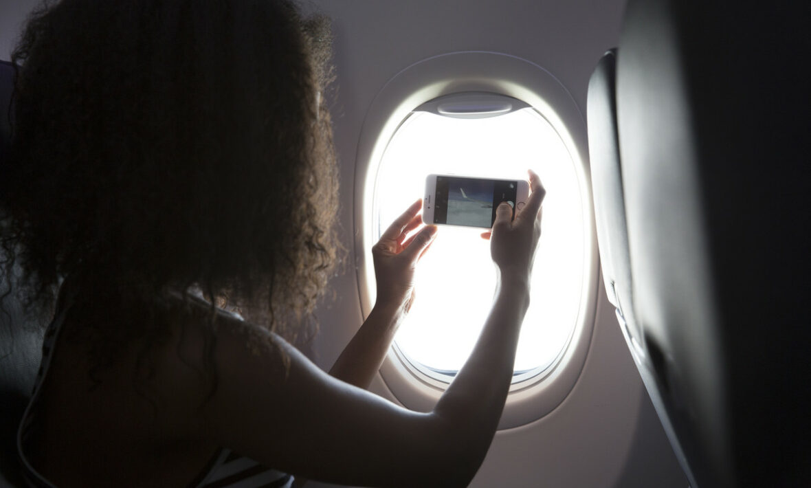 Girl taking picture on flight