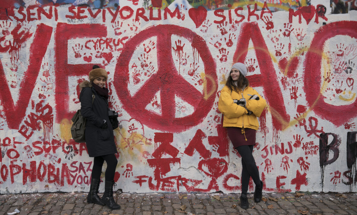 Political graffiti in red on a white exterior wall