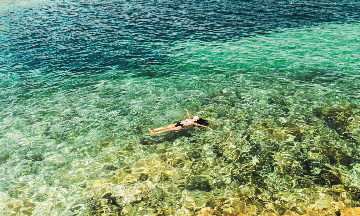 Woman floating in the sea on a Contiki