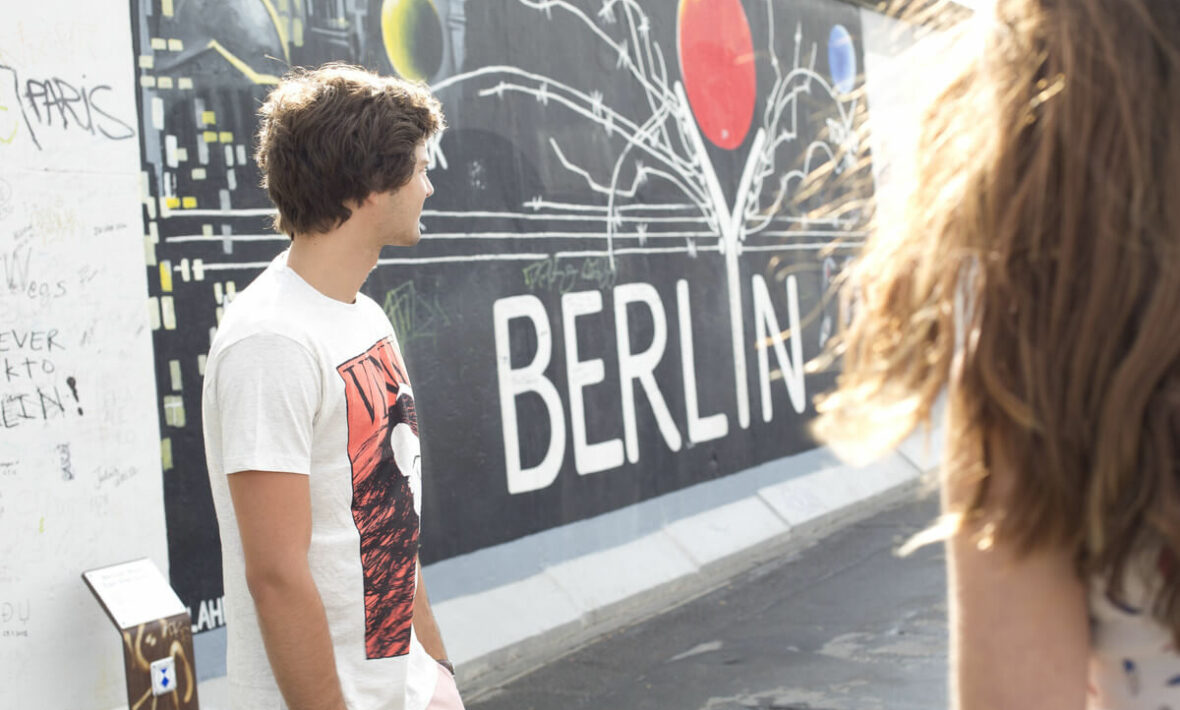 Two people in front of graffiti