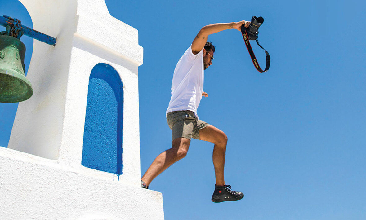 A travel addict soaring over a bell.