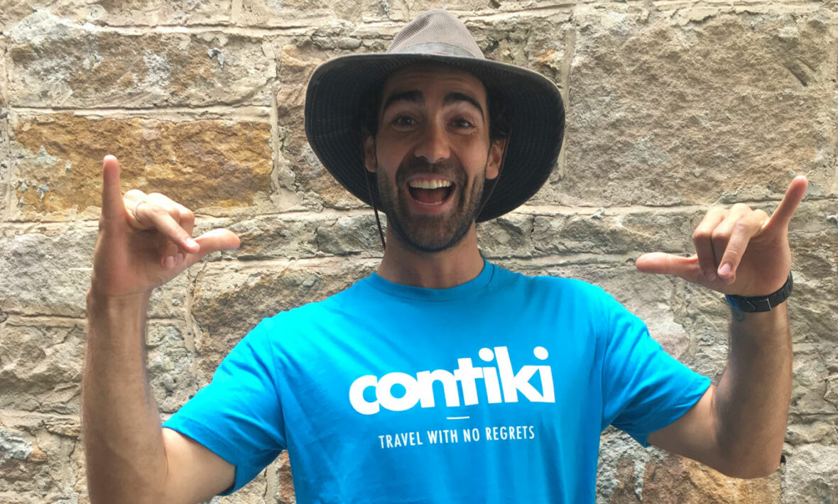 A man wearing a hat and t-shirt with the word contiki on it wins Cosmo Bachelor of the Year.