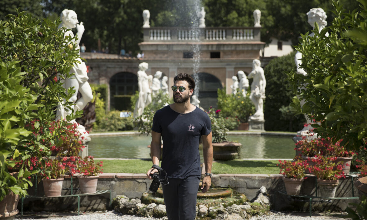 man walking with camera in garden