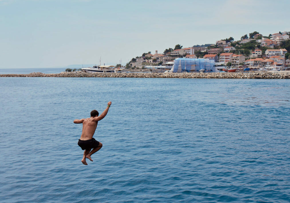 Boy jumping into Croatian sea