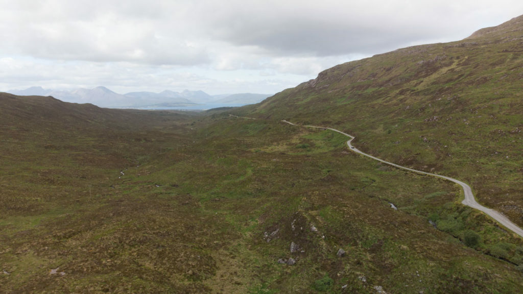 An aerial view of a winding road in Scotland with the opportunity to become a lord.