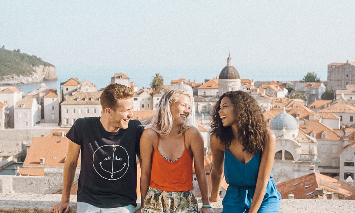 Three people standing on a balcony in Rome