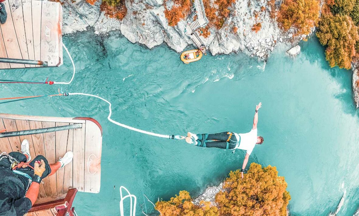 man bungee jumping off suspension bridge