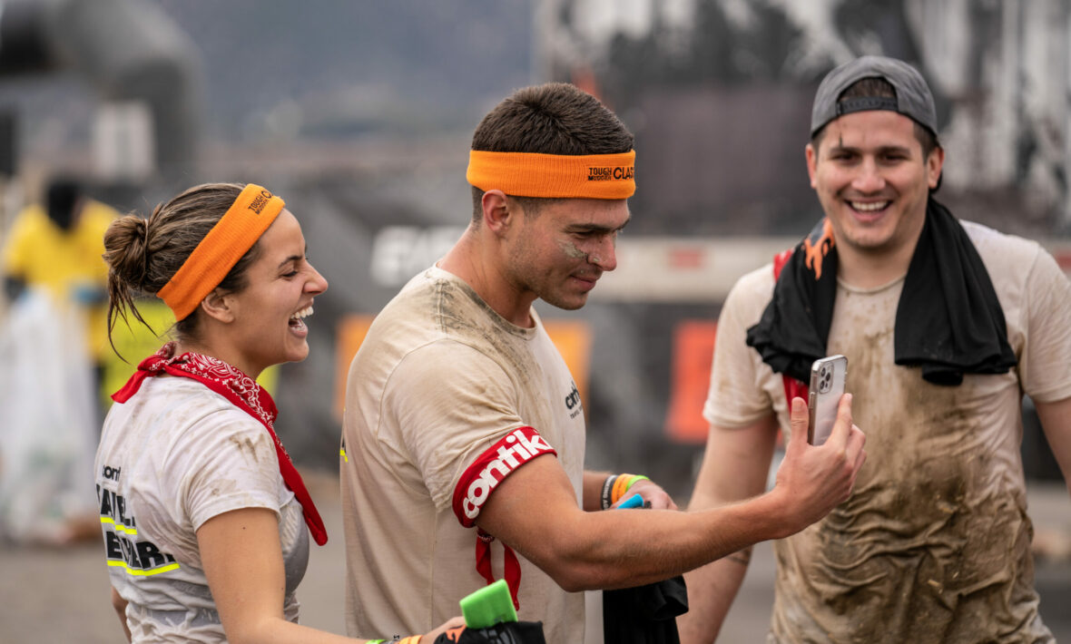 A group of people taking a selfie at Tough Mudder.