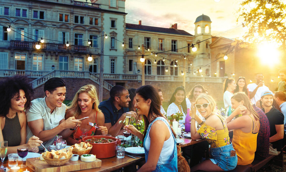 friends eating a meal on a balcony