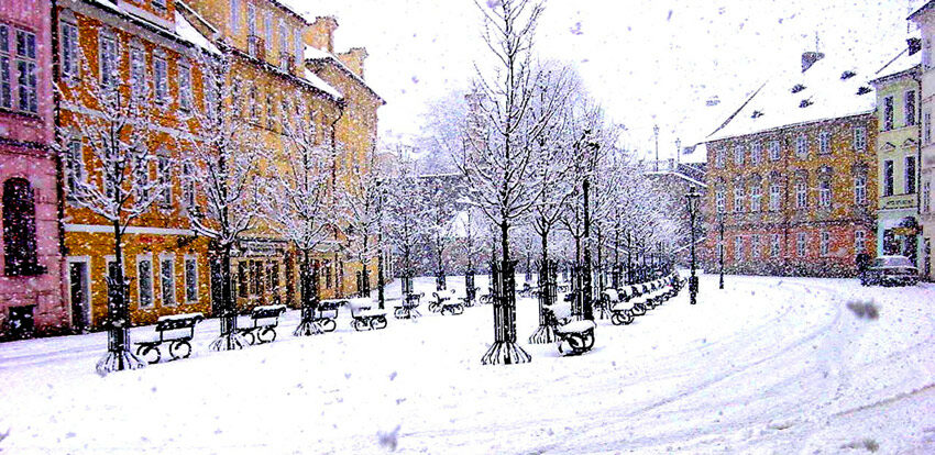 A street in Europe covered in snow during winter.