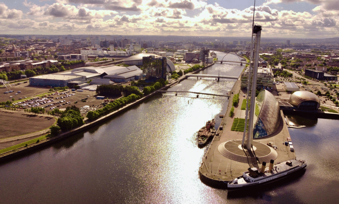 A boat is docked near a city.