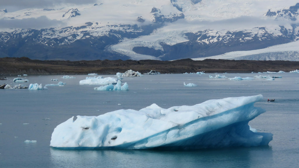 A group of icebergs floating in a body of water.