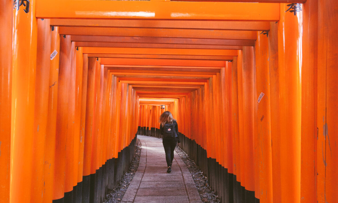 Women walking up path lined with bright orange posts