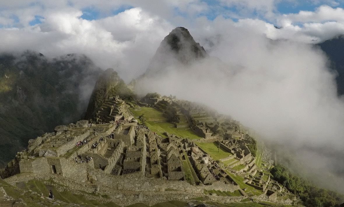 The ruins of Machu Picchu are surrounded by clouds.