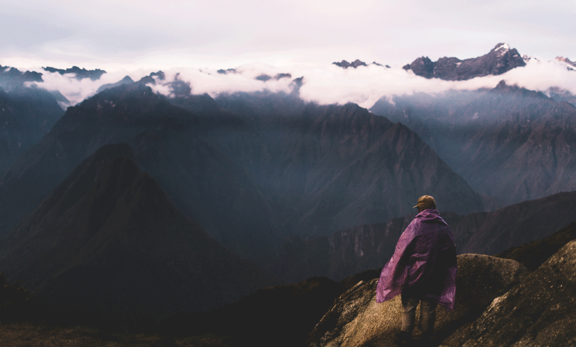 A person hiking the Inca Trail to reach the top of a mountain.