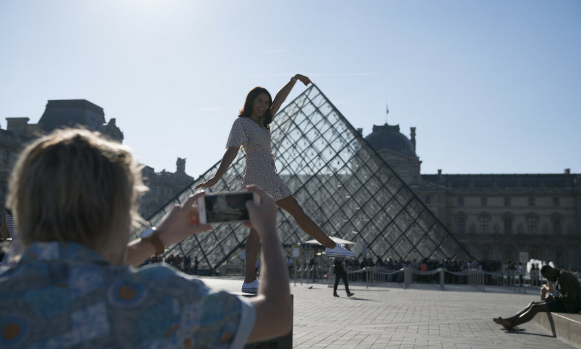 Taking picture in front of the Louvre, Paris