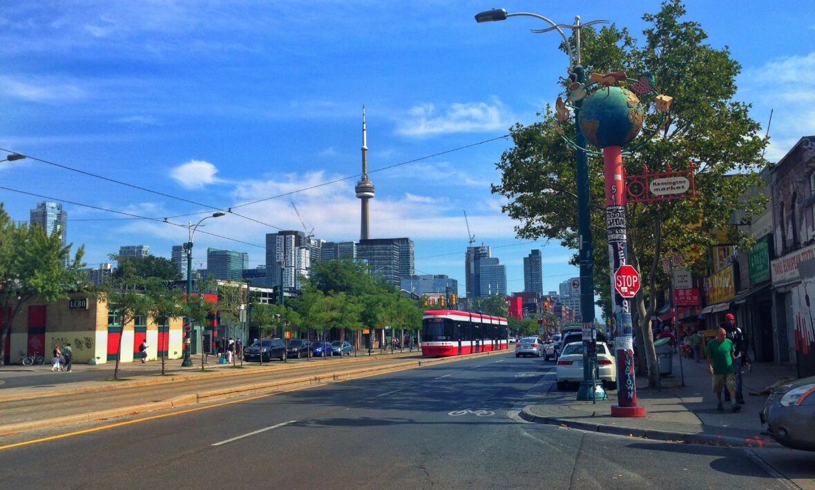 A 6ix city street with cars parked on it.