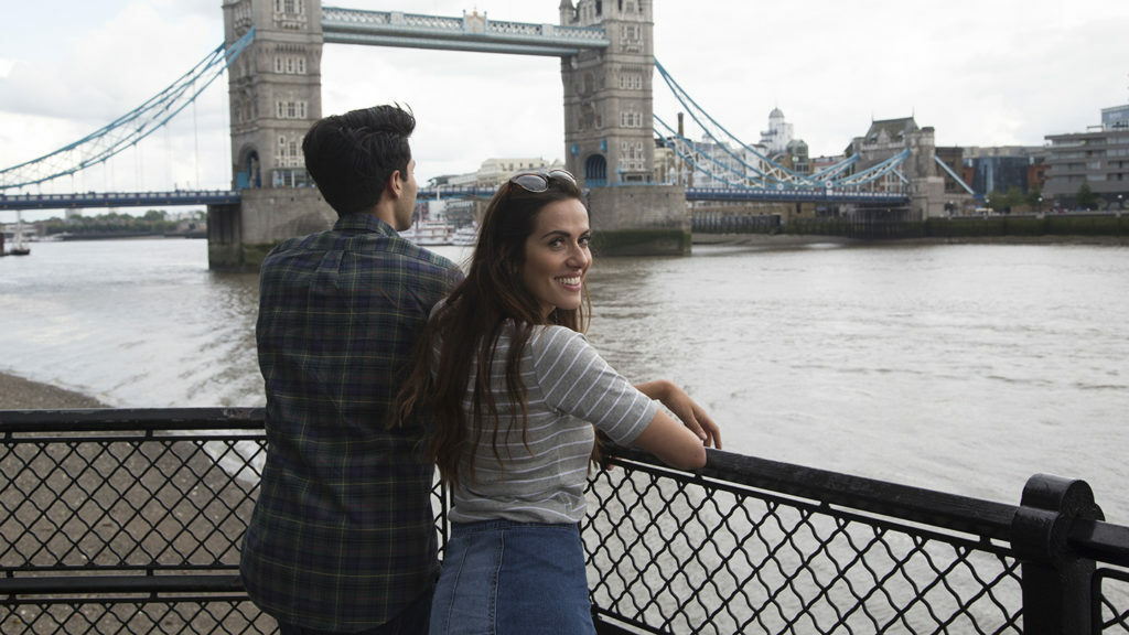 A couple traveling in the UK admiring Tower Bridge in London.