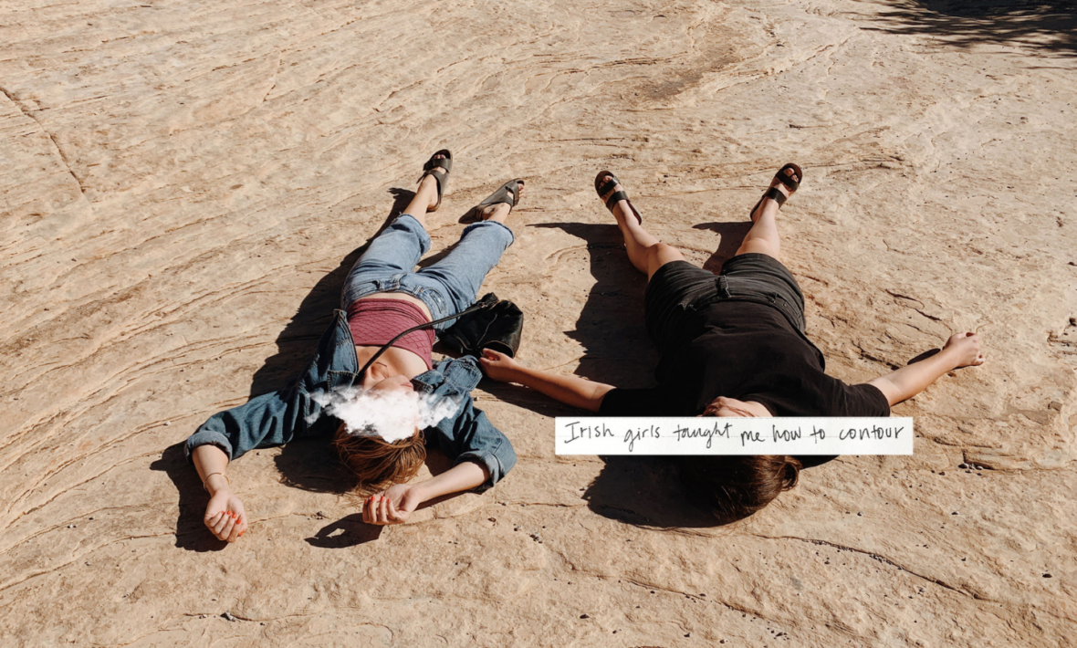 Two people laying on the ground with a quote.